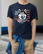 Cute Star Spangled Alaskan Sled Dog Independence Day Tshirt - model wearing navy tee with hands in pockets