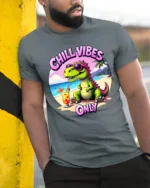 Hilarious Chill Vibes Only Dinosaur Beach Tropical Graphic Tee - model wearing grey tee, leaning on column