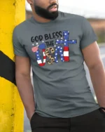 Faithful Stars And Stripes American Pride Graphic Tshirt - model wearing grey tee, leaning on column