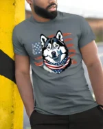 Cute Star Spangled Alaskan Sled Dog Independence Day Tshirt - model wearing grey tee, leaning on column