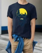 Cool Skull Camping Graphic Tee Outdoor Adventure Sunset Tshirt - model wearing navy tee with hands in pockets