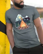 Campfire Mountain Adventure Outdoor Nature Vibes Graphic T Shirt - model wearing grey tee, leaning on column