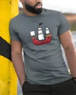 Cute Cartoon Pirate Ship Minimal Style Ocean Adventure Graphic Tee Tshirt - model wearing grey tee, leaning on column