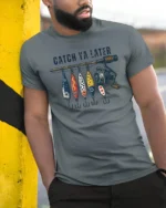 Catch Ya Later Funny Fishing Lures Vintage Graphic T Shirt - model wearing grey tee, leaning on column