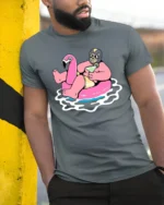 Funny Flamingo Pool Party Graphic Tee Summer Drink Cartoon Tshirt - model wearing grey tee, leaning on column