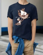 Funny Kraken Attack Pirate Ship Adventure Graphic Tshirt - model wearing navy tee with hands in pockets