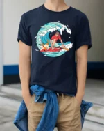 Funny Surfing Dog and Boy Summer Adventure Graphic T-shirt - model wearing navy tee with hands in pockets