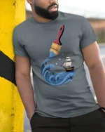 Creative Ocean Paint Brush Wave Ship Artistic Graphic T Shirt - model wearing grey tee, leaning on column