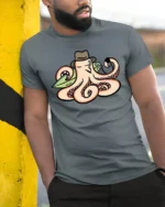 Cool Octopus Surfer with Hat and Pipe Funny Graphic Tee - model wearing grey tee, leaning on column