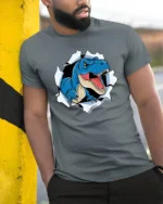 Scary Blue T-Rex Dinosaur Breaking Through Graphic Tshirt - model wearing grey tee, leaning on column