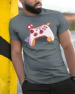 Retro Video Game Controller with Power-Up Mushroom Soft Tee - model wearing grey tee, leaning on column