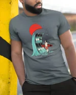 Surreal Surfer Sunset Giant Wave Graphic Soft Tshirt - model wearing grey tee, leaning on column
