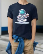 Funny Tropical Astronaut Coconut Ice Cream Graphic Soft Tee - model wearing navy tee with hands in pockets