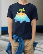Adorable Sea Island Manatee Tropical Paradise Graphic Tee - model wearing navy tee with hands in pockets