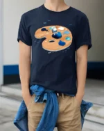 Creative Artistic Astronaut Painter Space Palette Graphic Tshirt - model wearing navy tee with hands in pockets