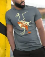 Eco Awareness Bird Skeleton Plastic Pollution Graphic Tee - model wearing grey tee, leaning on column