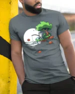 Cute Cat Fishing On Floating Island Full Moon Graphic Tee - model wearing grey tee, leaning on column