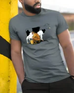 Authentic Traditional Farmer Hand Milking Cow Udder Tee - model wearing grey tee, leaning on column
