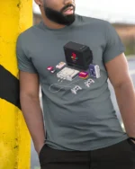 Retro Pixel Tech Console And Walkman Isometric Graphic Tshirt - model wearing grey tee, leaning on column