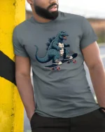Radical Skater Kaiju Monster King Skateboard Soft Tshirt - model wearing grey tee, leaning on column