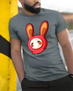 Playful Kawaii Rabbit Costume Character Red Graphic Tshirt - model wearing grey tee, leaning on column