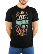 Don’t Let Idiots Ruin Your Day Graphic Tee - model wearing black tee with hands behind back