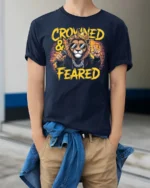Crowned and Feared Lion Hip Hop Graphic Tee - model wearing navy tee with hands in pockets