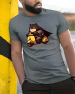Chibi Hero Yellow Scooter Ride Graphic Tee - model wearing grey tee, leaning on column