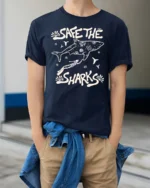 Save The Sharks Ocean Diver Protection Graphic Tee - model wearing navy tee with hands in pockets