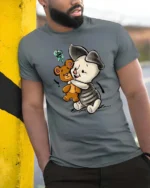 Adorable Hugging Piglet Teddy Bear Friend Graphic Tee - model wearing grey tee, leaning on column