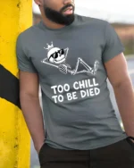 Amusing Too Chill To Be Died King Skeleton Novelty Tshirt - model wearing grey tee, leaning on column