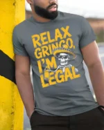 Relax Gringo I’m Legal Sombrero Skeleton Graphic Tee - model wearing grey tee, leaning on column
