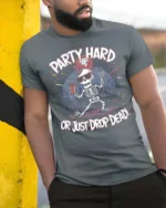 Amusing Party Hard Or Just Drop Dead Skeleton Graphic Tee - model wearing grey tee, leaning on column