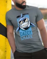 Catchy Daddy Shark Sunglasses Ocean Predator Graphic Tee - model wearing grey tee, leaning on column