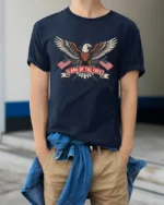 Proud Home Of The Brave United States National Slogan Tee - model wearing navy tee with hands in pockets