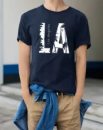Coastal Urban Skyline Palm Tree Monochromatic Graphic Tee - model wearing navy tee with hands in pockets