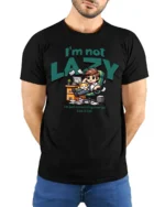 Funny Lazy Employee Sleeping Kitten Workspace Graphic Tee - model wearing black tee with hands behind back