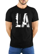 Coastal Urban Skyline Palm Tree Monochromatic Graphic Tee - model wearing black tee with hands behind back
