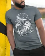 Monochrome Cool Eagle Backward Cap Patriotic Graphic Tshirt - model wearing grey tee, leaning on column