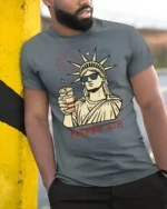 Lady Liberty Sunglasses Happy 4th Fireworks Graphic Tshirt - model wearing grey tee, leaning on column