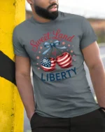 Charming Fruit Star Spangled Banner United States Soft Tshirt - model wearing grey tee, leaning on column