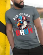 Patriotic Bruh Eagle Backward Hat Fireworks Graphic Tee - model wearing grey tee, leaning on column