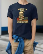 Relatable Mentally I’m Here Office Desk Skull Graphic Tee - model wearing navy tee with hands in pockets