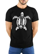 Aesthetic Surfboards Sea Turtle Tribal Line Art Graphic Tee - model wearing black tee with hands behind back