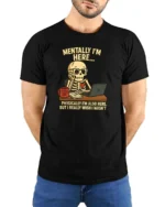 Relatable Mentally I’m Here Office Desk Skull Graphic Tee - model wearing black tee with hands behind back