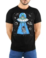 Creative Alien Spaceship Astronaut Swing Cosmic Graphic Tee - model wearing black tee with hands behind back