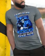 Blue Grumpy Old Man Skeleton Poker Player Graphic Tee - model wearing grey tee, leaning on column