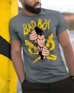 Bad Boy Cracking Wall Anime Mascot Graphic Tee - model wearing grey tee, leaning on column