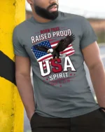 Inspiring Born Free Raised Proud Eagle Patriotic Graphic Tee - model wearing grey tee, leaning on column