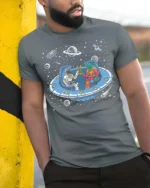 Awesome Extraterrestrial Spaceman Cheers Drinking Tshirt - model wearing grey tee, leaning on column